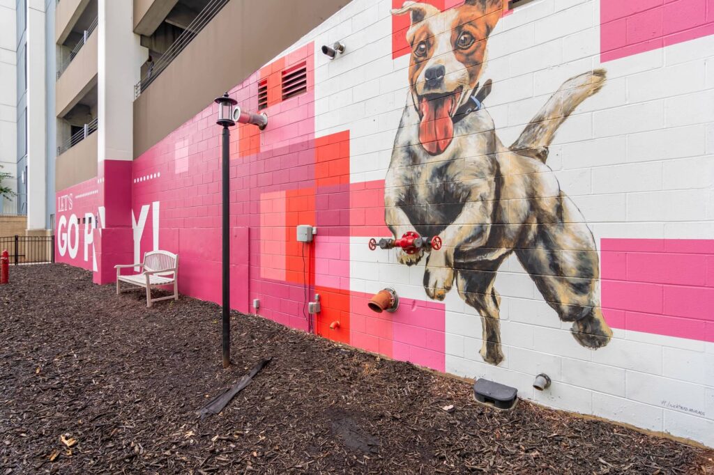 Lets go play with dog mural on the side of the parking garage