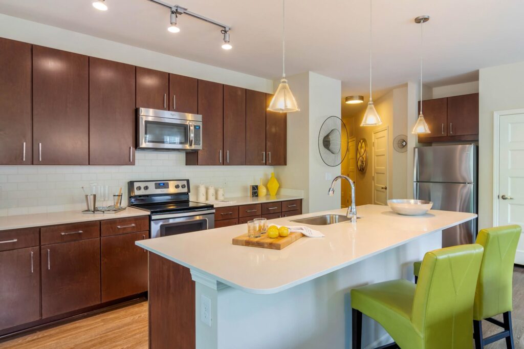 Kitchen with stainless steel appliances and kitchen island with bar stools