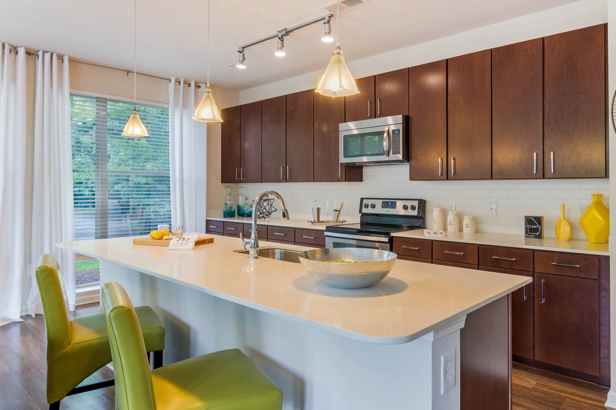 Kitchen with stainless steal appliances and kitchen island with counter seating