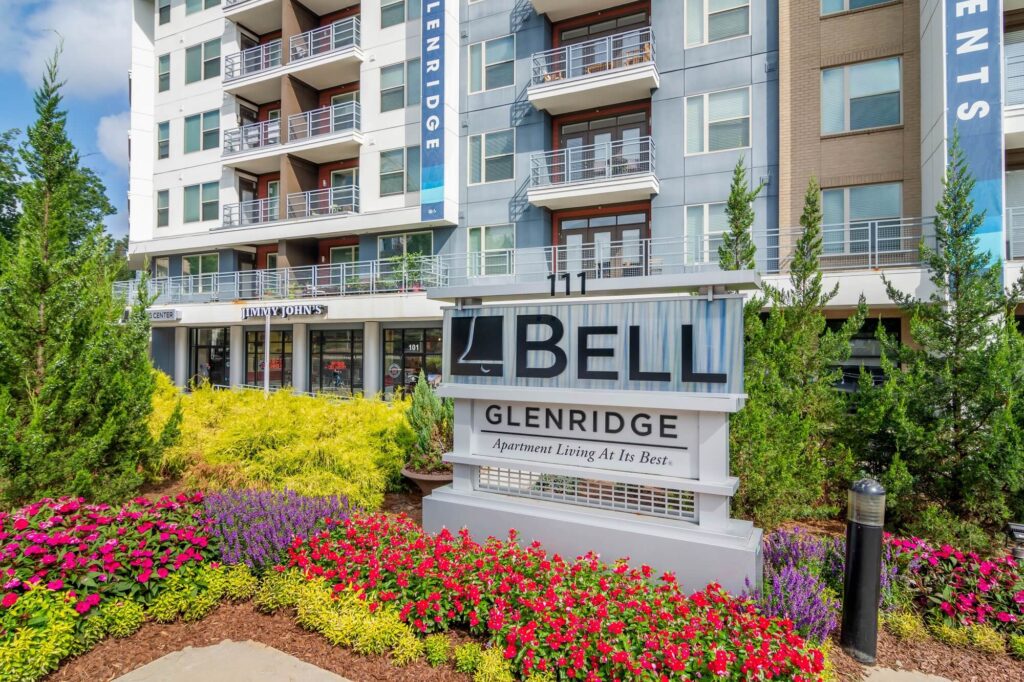 Bell Glenridge apartment living at its best sign in front of complex building. Jimmy johns located under neath community.