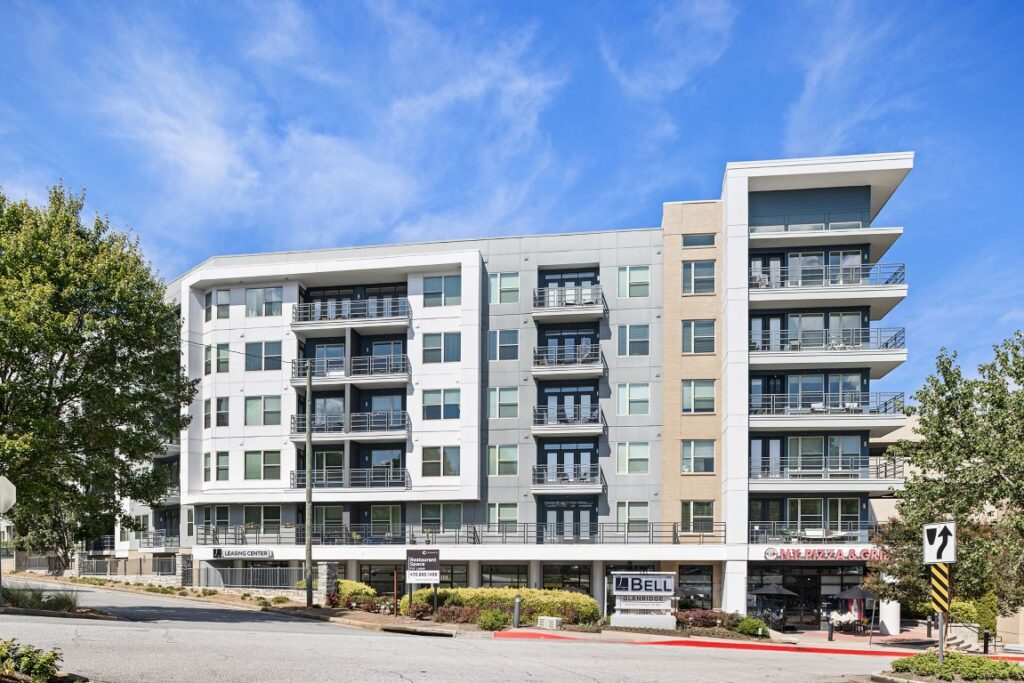 A multi-story apartment building with a leasing center and a restaurant on the ground floor.